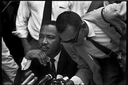 Martin Luther King Jr., center, and Rev. Ralph Abernathy, third from left, share a laugh outside court in Decatur, Ga., Oct. 25, 1960. Others are unidentified. Andrew Young is seen at center, facing right. (AP Photo)